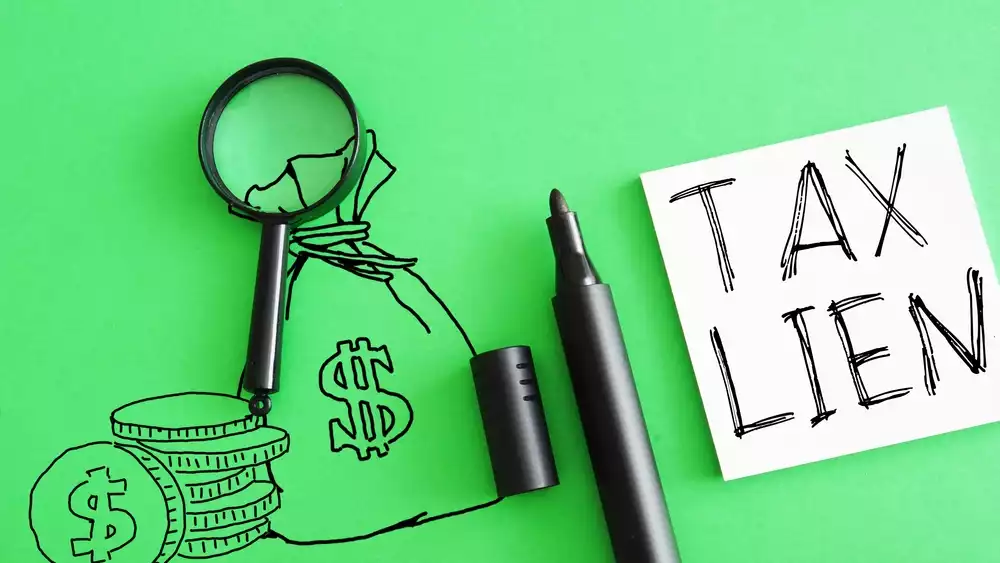 “Tax lien” written next to magnifying glass, drawings of money, and uncapped permanent marker
