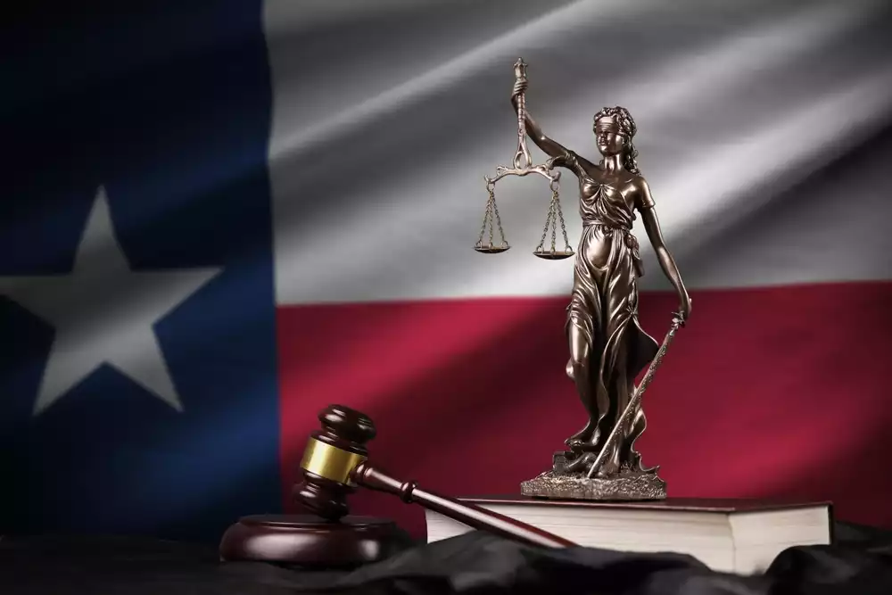 Lady Justice and gavel shown against a backdrop of the Texas state flag