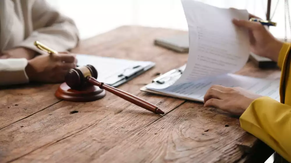 Attorney sits with client discussing property tax lawsuit in TX